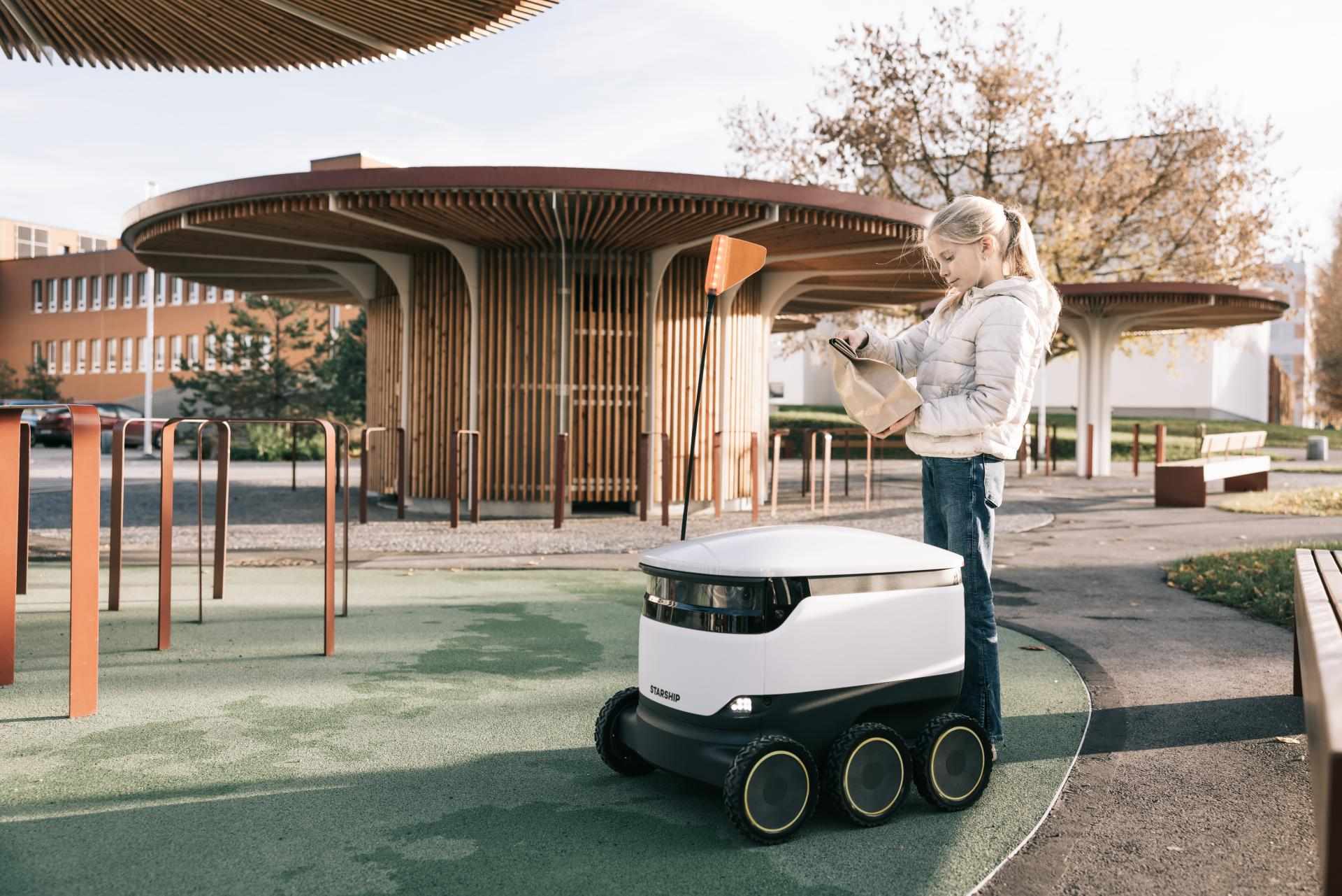 Girl Receiving Package From Starship Robot