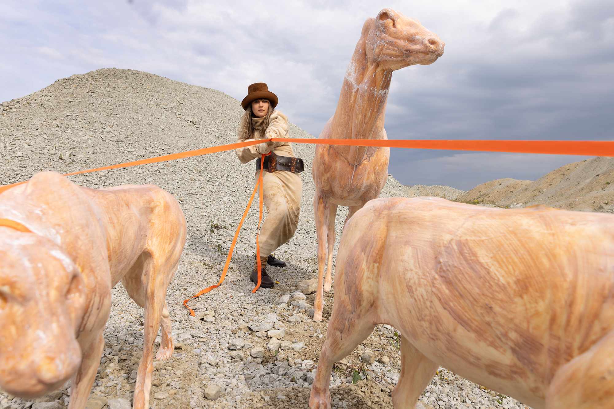 Edith Karlson outdoors with sculptural animal figures
