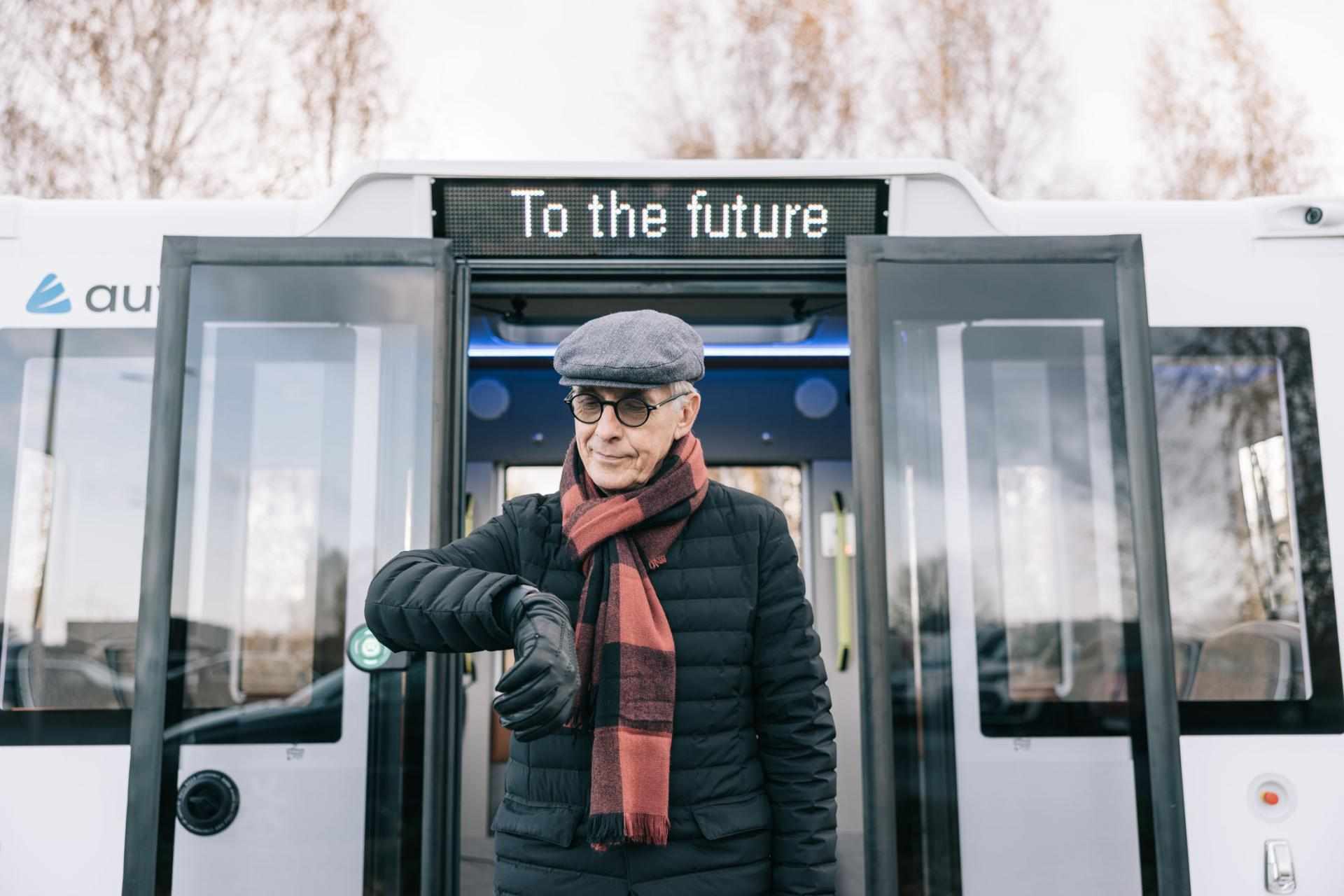 Man Standing in Front of Self Driving Bus